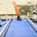 Blue conveyor plane with parts